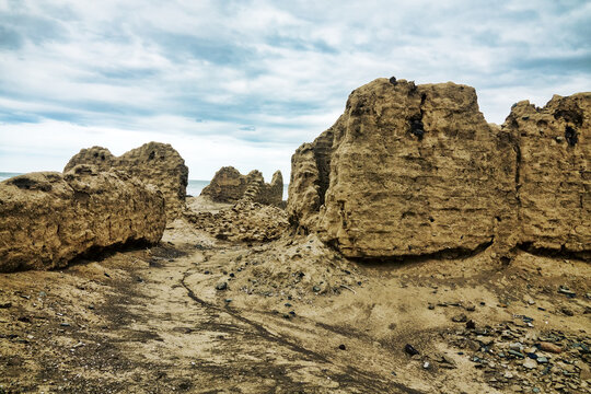 Calcareous remains of cubic shape on the shore of the Arabian Sea with traces of ancient coastal erosion. Oman
