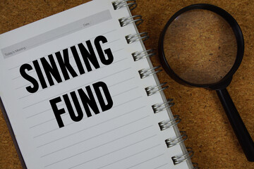 Sinking Fund text written on notebook paper with magnifying glass