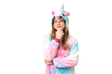Young girl with unicorn pajamas over isolated chroma key background with glasses and smiling