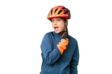 Young cyclist girl over isolated chroma key background celebrating a victory