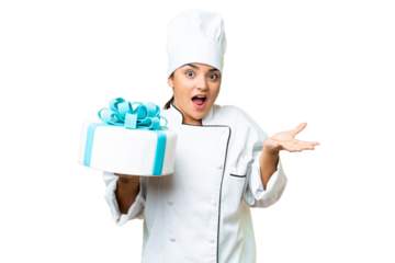 Woman pastry chef with a big cake with shocked facial expression