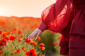 Pretty girl in red dress posing in poppy flower fields. Happiness and love with music.