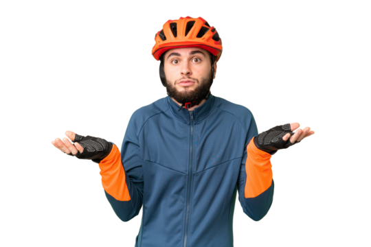 Young cyclist man over isolated chroma key background having doubts while raising hands