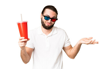 Young handsome man holding soda while watching a 3D movie over isolated chroma key background making doubts gesture while lifting the shoulders