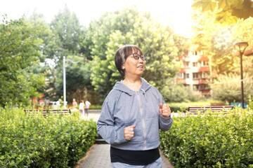 Vibrant Jchinese senior women doing preparatory exercises and stretching. Images of health,...