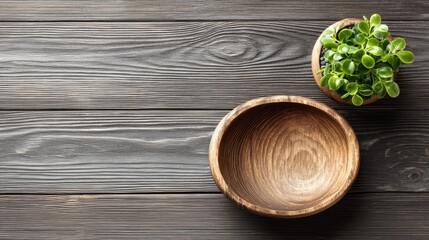 Wooden bowls and a small plant on a dark wooden table.