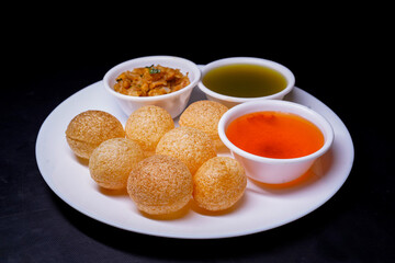 Delicious north and south indian street food pani puri gol gappa with tamarind water served in white plate and potato and chickpeas © Black Spade Design
