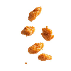 A close-up image showing four crispy golden chicken nuggets floating gracefully against a transparent background
