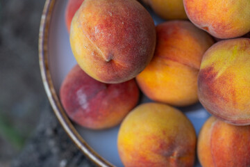 Pile of Fresh, Ripe Peaches Displayed Outdoors