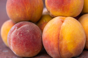 Pile of Fresh, Ripe Peaches Displayed Outdoors