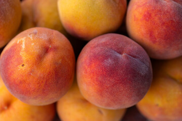 Pile of Fresh, Ripe Peaches Displayed Outdoors