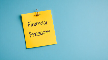 Financial Freedom: A yellow sticky note with "Financial Freedom" written in black marker on a light blue background symbolizes financial independence.