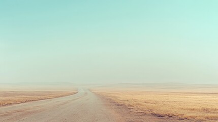 Fototapeta premium Empty road through a hazy landscape