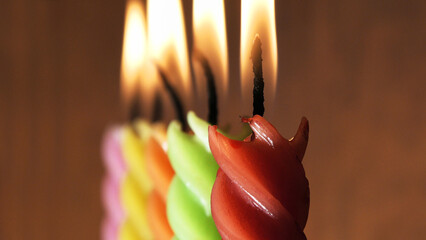 Christmas New Year decoration with lit colorful curly candles