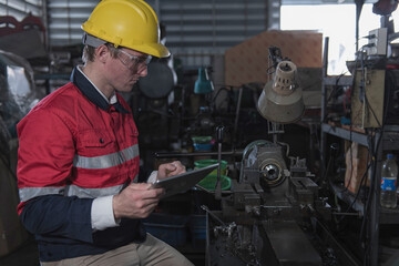 industrial workers at work. industrial workers in factory. portrait of a worker. worker wear helmet in factory.