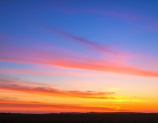 Obraz premium Vibrant Sunset Colors Over A Field
