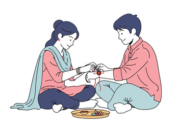 Woman tying rakhi on man's wrist for raksha bandhan