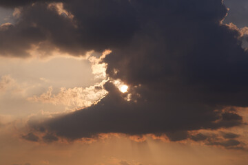 Breathtaking summer evening sunset with dramatic clouds, captured at 7 pm in July, showcasing nature's beauty over a vibrant landscape.