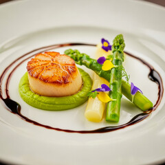 Seared scallop with green pea puree asparagus and edible flowers image