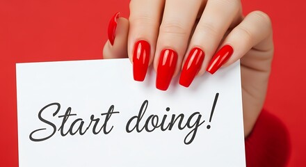 Elegant hands holding 'Start doing' card with bright red manicure and a motivational message for