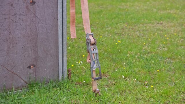 Polyester Ratchet Lashing Belt Cam Buckle Strap Used to Support Temporary Outdoor Structure Anchored to the Ground