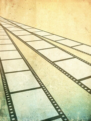 Fototapeta premium Grunge background with old paper texture and retro filmstrip frame. Horizontal or vertical retro banner with film reel. Vintage backdrop with filmstrips. Copy space for text