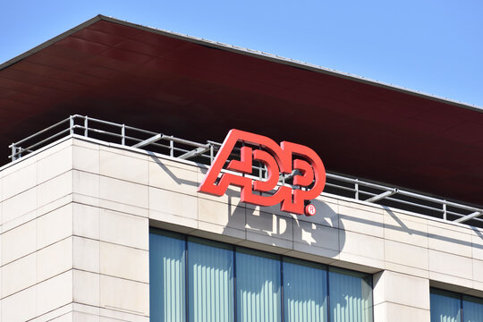 ADP (Automatic Data Processing) company office with signage, logo, emblem on the facade. American provider of human resources management software and services. WARSAW, POLAND - MARCH 13, 2022