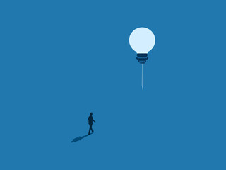 businessman follows a lightbulb floating in the sk