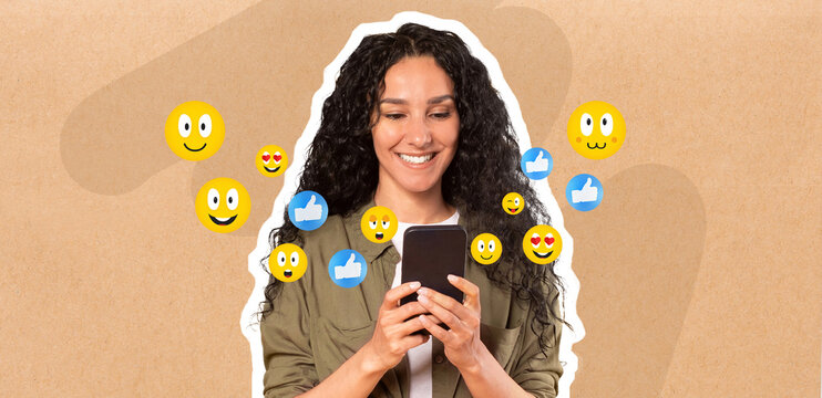 A woman with curly hair smiles while holding a smartphone, actively engaged in messaging. Colorful emojis appear around, suggesting social media interaction and enjoyment in a light-hearted setting.