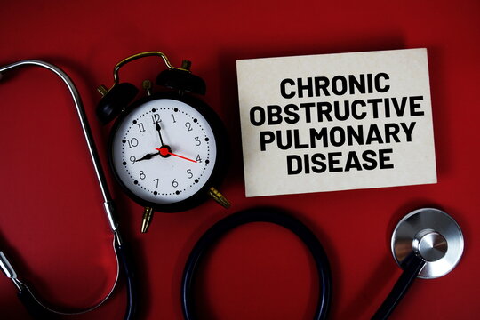 Chronic Obstructive Pulmonary Disease text written on paper card with stethoscope and alarm clock on red background