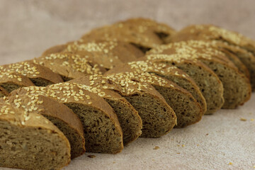 Sliced whole grain bread. Sesame bread close-up. Lots of baked goods in the form of bread.