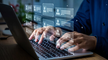 Hands typing on a laptop with glowing digital data interfaces appearing above the keyboard