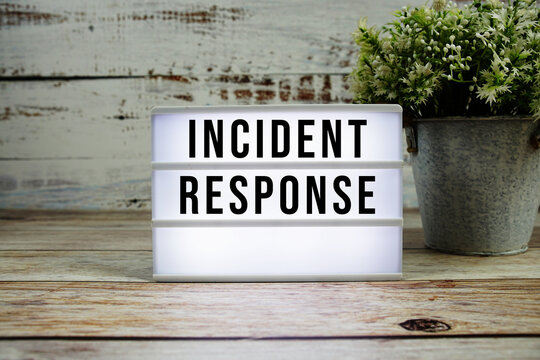 Incident Response text on light box with alarm clock on wooden background - Powered by Adobe