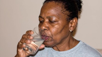 Senior woman drinking water