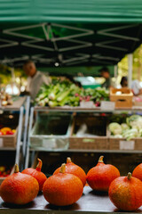 Fresh vegetables at small local urban market. Organic produce on sale at outdoor farmer market. Selling fresh crops and veggies harvest. European urban setting. Close up. Part of the series