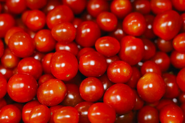 Fresh tomatoes at small local urban market. Organic produce on sale at outdoor farmer market. Selling fresh crops and veggies harvest. European urban setting. Close up. Part of the series