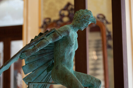 CARTAGENA, SPAIN - Side profile of bronze sculpture with green patina depicting winged Icarus in historic interior in Cartagena Murcia.   