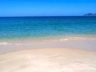 Famous paradise beach in Troia near Lisbon in Portugal with white sand and deep blue sea