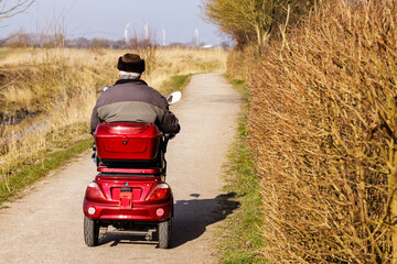 single old man on an electric wheelchair 