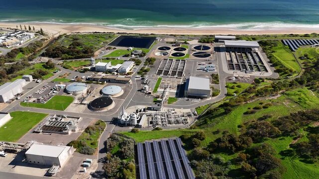 SA Water Christies Beach Wastewater Treatment Plant, O'Sullivan Beach, South Australia: 4K Aerial Drone Footage of Coastal Facility, Clarifier Tanks, Infrastructure, Solar Panels, and Nearby Beach