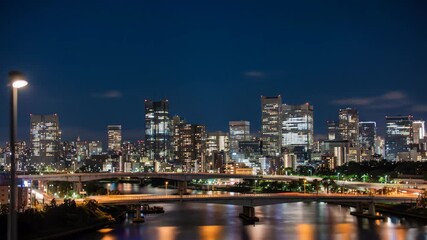 Stunning cityscape at night with blurred lights and vibrant reflections offering a dynamic urban background for travel videos and modern city life