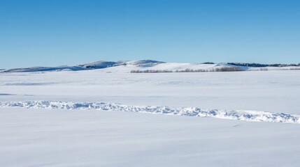 Vast Winter Landscape with Snowy Hills Against Clear Blue Sky
