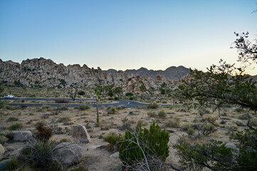 Golden hour light on rugged cliffs in Joshua Tree National Park.
