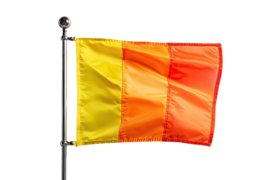 A three-color flag, yellow, orange, and red, billowing in the wind, mounted on a metal pole