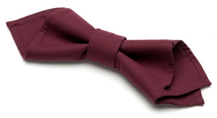 Maroon napkin folded in a bow shape, resting on a white background. Close-up shot with soft lighting.