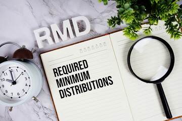 RMD - Required Minimum Distributions acronym on notepad, Business concept background