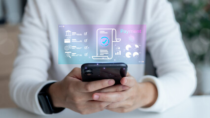 Close-up hand holding smartphone with hologram digital bill and payment icons. Fintech, mobile banking, and online financial transaction technology concept.