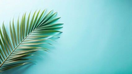 Fototapeta premium Serene Tropical Leaf on a Light Teal Background, Perfect for Summer Designs and Relaxation Themes