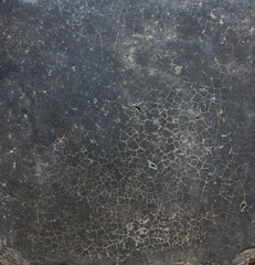 Cracked Dark Surface. Close-up of a dark cracked surface with fine web-like lines, evoking an aged or weathered appearance.