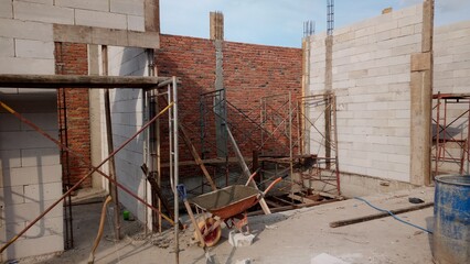 Building under construction. Combination of red brick and white lightweight brick.